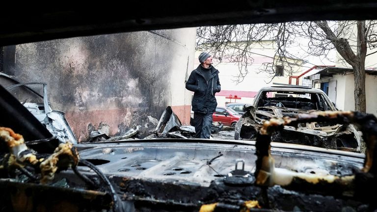 A resident walks near damaged cars at the site of a Russian drone strike in Odesa, Ukraine February 17, 2026. Reuters
