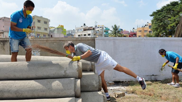 Bengaluru captain Sunil Chhetri and coach Ashley Westwood clean in the neighbourhood of the football stadium in Bangalore in 2014