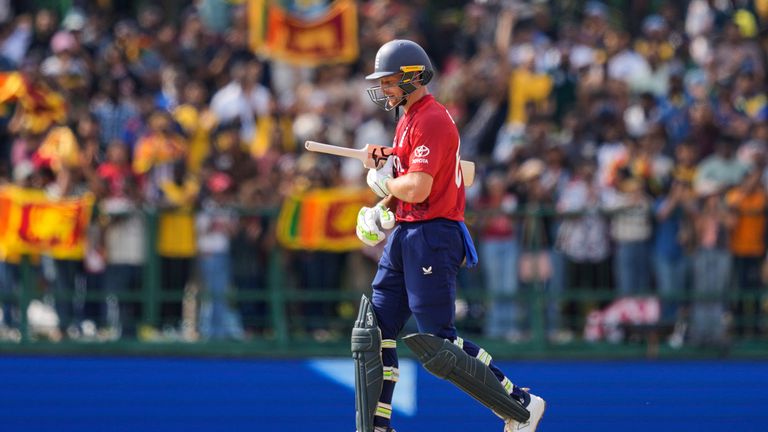 England's Jos Buttler leaves the ground after losing his wicket during the T20 World Cup cricket match between Sri Lanka and England in Pallekele, Sri Lanka, Sunday, Feb. 22, 2026. (AP Photo/Eranga Jayawardena)