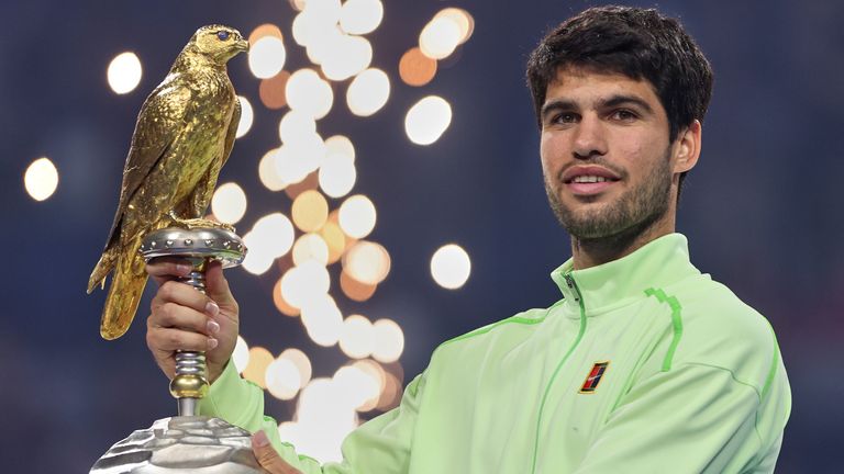 Carlos Alcaraz holds the trophy after beating Arthur Fils the final of the Qatar Open