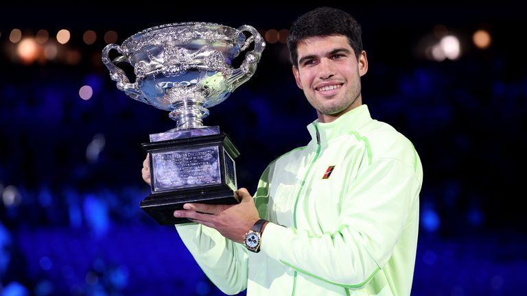 Spain's Carlos Alcaraz poses with the Norman Brookes Challenge Cup after defeating Serbia's Novak Djokovic in the men's singles final on Day