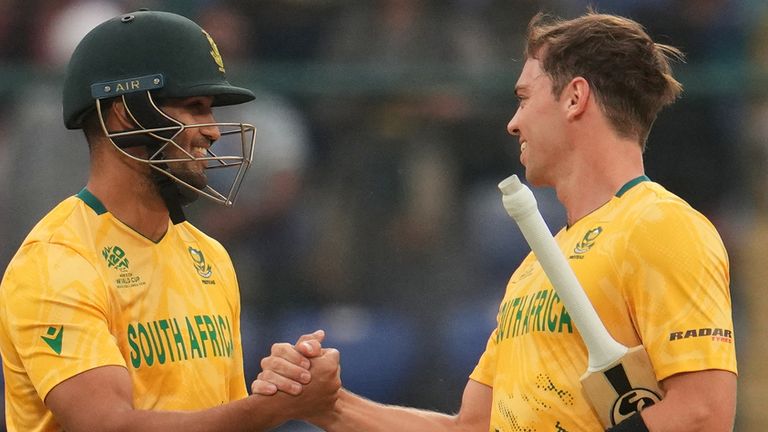 South Africa's Jason Smith, left, congratulates Tristan Stubbs after winning the T20 World Cup cricket match between South Africa and United Arab Emirates in New Delhi, India, Wednesday, Feb. 18, 2026. (AP Photo/Manish Swarup)