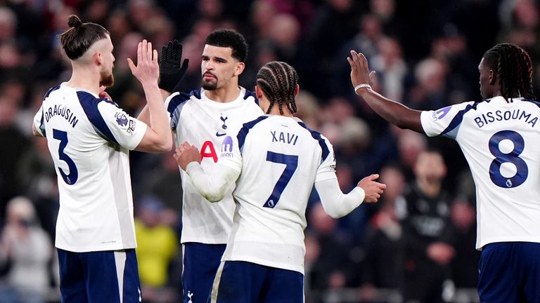 Dominic Solanke celebrates with team-mates after pulling a goal back for Spurs