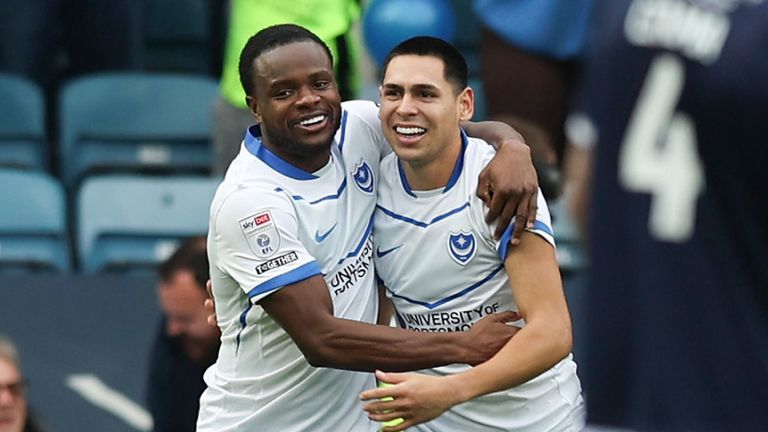 Gustavo Caballerocelebrates with team-mate Millenic Alli after opening the scoring for Portsmouth at Millwall