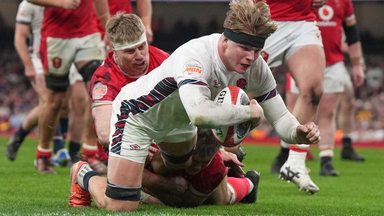 England's Henry Pollock crosses to score a try during the Six Nations rugby union match between Wales and England at the Principality Stadium in Cardiff, Wales, Saturday, March 15, 2025. (AP Photo/Alastair Grant)
