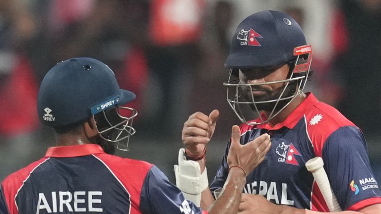Nepal's Dipendra Singh Airee with batting partner Gulshan Jha celebrate after they won against Scotland during the T20 World Cup