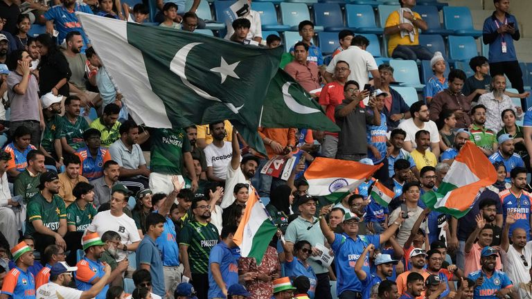 Pakistan and Indian supporters wave flags to cheer for their teams ahead of the Asia Cup cricket match between India and Pakistan
