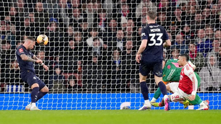 Wigan Athletic's Jack Hunt scores an own goal to make it 3-0 to Arsenal