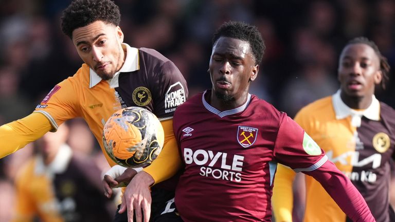 Burton Albion's Kain Adom and West Ham's Soungoutou Magassa compete for possession