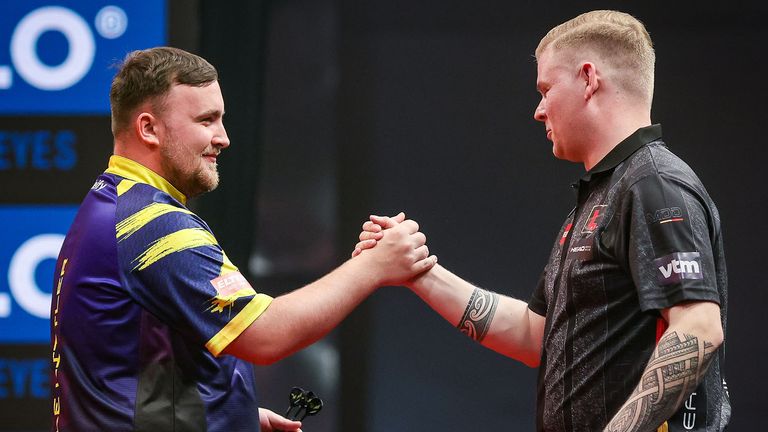 Luke Littler shakes hands with Mike De Decker in Poland (Pic: PDC Europe)