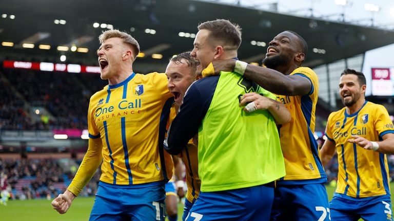 Mansfield Town's Louis Reed celebrates scoring their side's second goal of the game during the Emirates FA Cup fourth round match at Turf Moor, Burnley. Picture date: Saturday February 14, 2026. PA Photo. Photo credit should read: Richard Sellers/PA Wire...RESTRICTIONS: EDITORIAL USE ONLY No use with unauthorised audio, video, data, fixture lists, club/league logos or "live" services. Online in-match use limited to 120 images, no video emulation. No use in betting, games or single club/league/player publications.