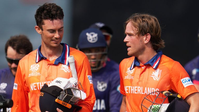 Netherlands' captain Scott Edwards, left and Netherlands' Bas de Leede walks out of the field after their win over Namibia during the T20 World Cup cricket match between Namibia and Netherlands in New Delhi, India, Tuesday, Feb. 10, 2026. (AP Photo/Manish Swarup)