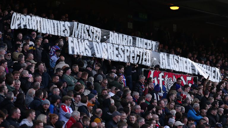Crystal Palace fans hold up a banner against the club board and manager Oliver Glasner