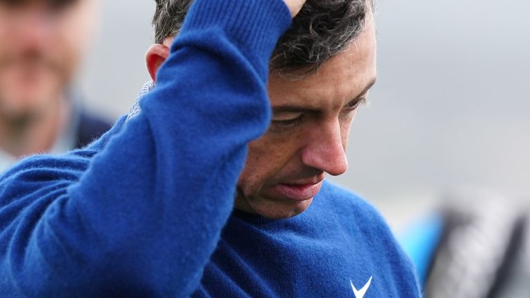 Rory McIlroy reacts to missing a short putt as he walks off the 18th green