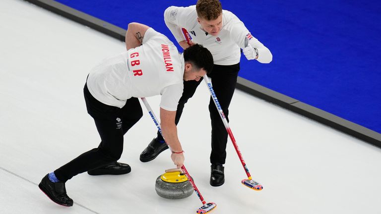 Britain's Bobby Lammie and Hammy McMillan sweep ahead of a stone during a men's curling round robin match against Czechia