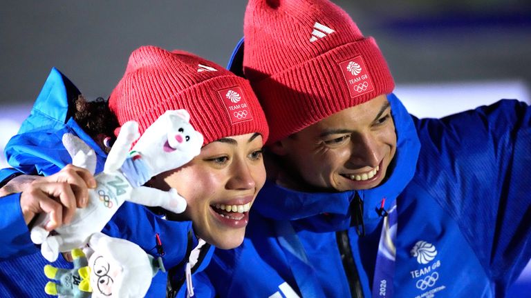 Britain's gold medalists Matt Weston, right, and Tabitha Stoecker, left, pose for a photo after the skeleton mixed team competition at the 2026 Winter Olympics, in Cortina d'Ampezzo, Italy, Sunday, Feb. 15, 2026. (AP Photo/Aijaz Rahi)
