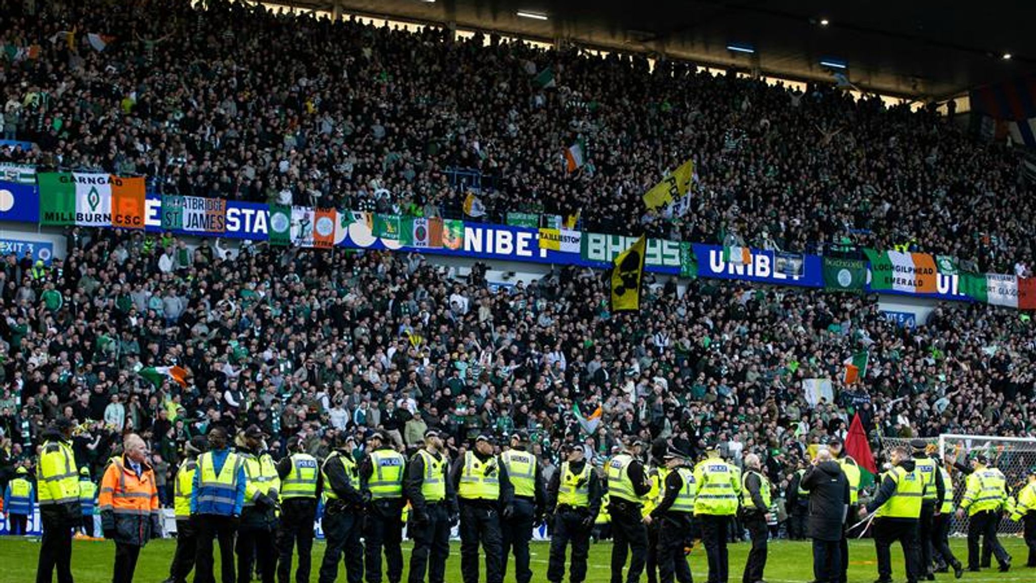 Police had to keep Rangers and Celtic fans apart after they ran onto the pitch at Ibrox in March