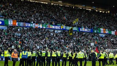 Police had to keep Rangers and Celtic fans apart after they ran onto the pitch at Ibrox