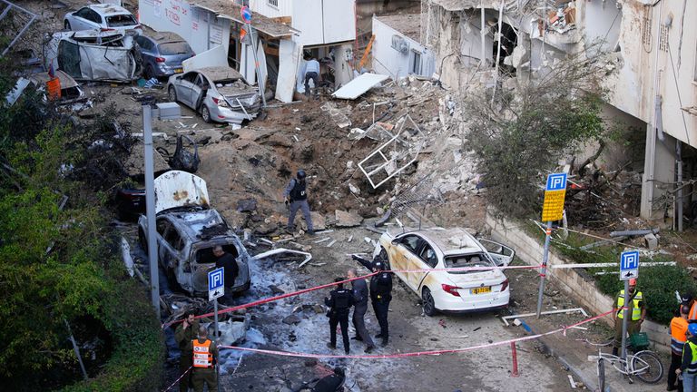 Israeli security and rescue forces respond at the site of an Iranian missile strike in Tel Aviv, Israel. Pic: AP