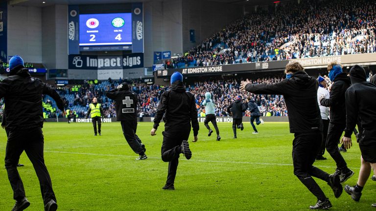 Fans storm the pitch at full time during the Scottish Cup Quarter-Final match between Rangers and Celtic