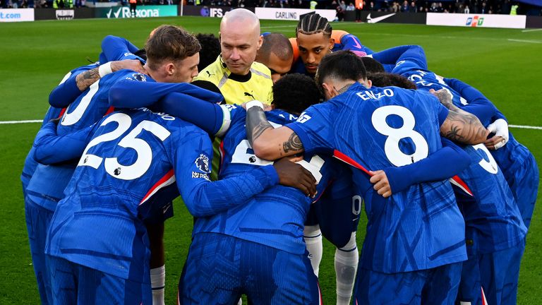 Referee Paul Tierney is surrounded by Chelsea's pre-match huddle before facing Newcastle
