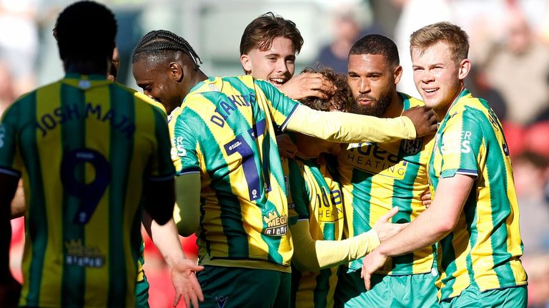 George Campbell is mobbed by his team-mates after heading West Brom into the lead against Bristol City