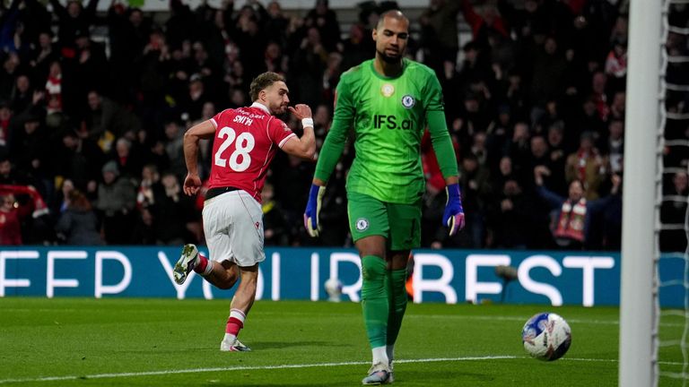 Sam Smith wheels away to celebrate after beating Robert Sanchez to give Wrexham a first-half lead against Chelsea