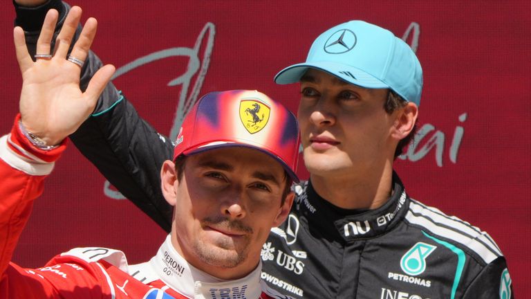 Winner Mercedes driver George Russell, right, of Britain waves with second place Ferrari driver Charles Leclerc of Monaco after the Sprint Race of the Chinese Formula One Grand Prix at the Shanghai International Circuit, in Shanghai, China, Saturday,
