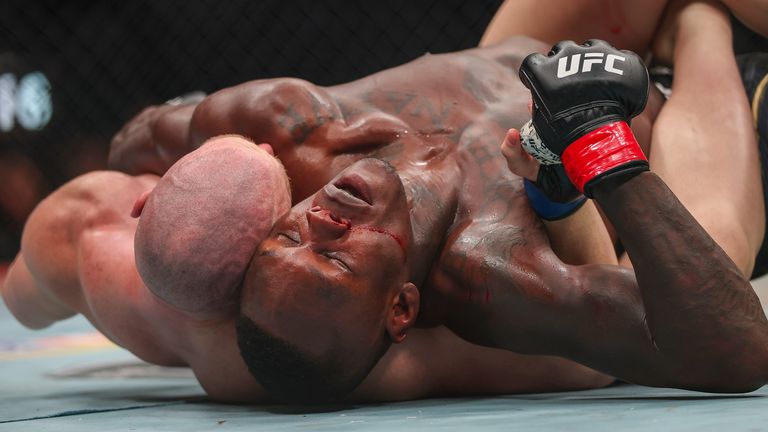 Israel Adesanya (right) and Joe Pyfer fight on the ground during their UFC middleweight bout in March 2026 (Getty Images)