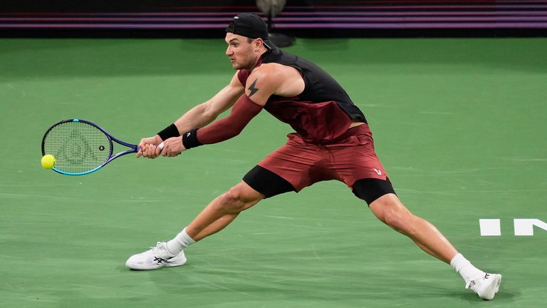 Jack Draper, of Britain, returns a shot against Daniil Medvedev, of Russia, during a quarterfinal match at the BNP Paribas Open tennis tournament, Thursday, March 12, 2026, in Indian Wells, Calif. (AP Photo/Mark J. Terrill)