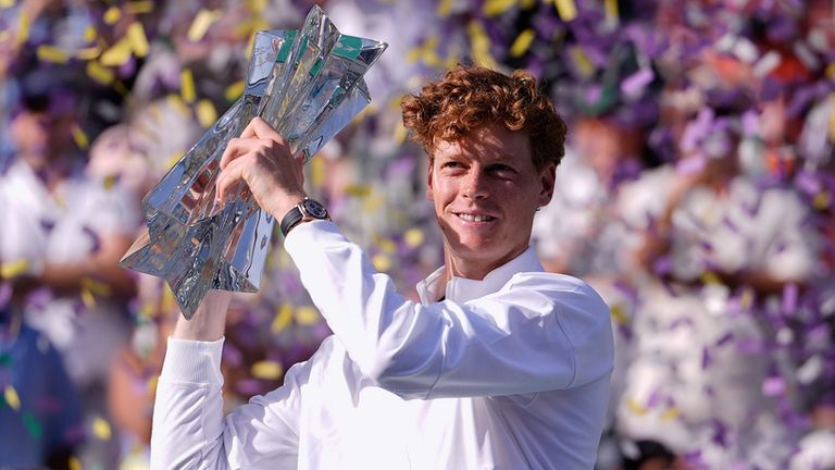 Jannik Sinner, of Italy, holds the winner's trophy after defeating Daniil Medvedev, of Russia, right, during a final match at the BNP Pariba