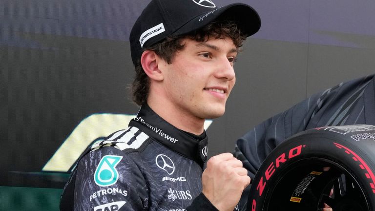 Mercedes driver Kimi Antonelli of Italy, left, poses with Japan's sumo wrestler Kotozakura after he clocked the fastest time in the qualifying session of the Japanese Formula One Grand Prix at the Suzuka Circuit in Suzuka, Japan, Saturday, March 28, 2026. (AP Photo/Eugene Hoshiko)