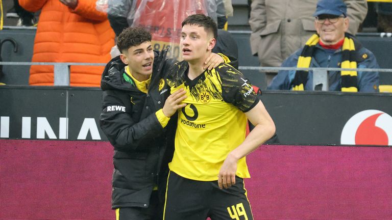 Samuele Inacio congratulates Luca Reggiani for scoring his first Bundesliga goal for Borussia Dortmund against Augsburg