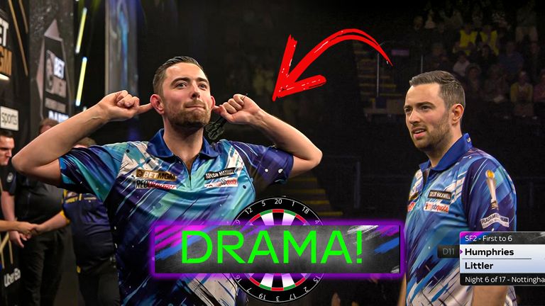 Luke Humphries cups his ears after defeating Luke Littler in Nottingham