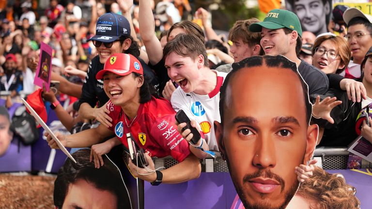 Fans react as they wait for driver arrivals ahead of the first practice session for the Australian Formula One Grand Prix at Albert Park, in Melbourne, Australia, Friday, March 6, 2026. (AP Photo/Scott Barbour)