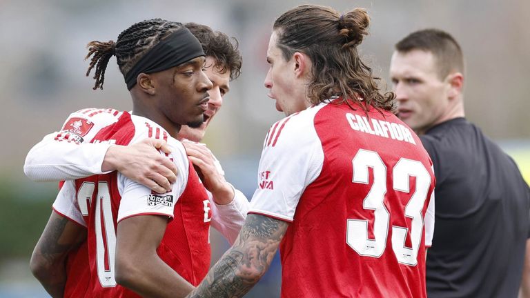 Noni Madueke is congratulated by his team-mates after scoring Arsenal's opening goal at Mansfield