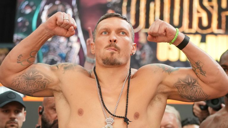 Ukraine's Oleksandr Usyk poses during the weigh-in in London, Friday, July 18, 2025 ahead of his world heavyweight boxing title fight against Britain's Daniel Dubois, right, on Saturday (AP Photo/Kin Cheung)