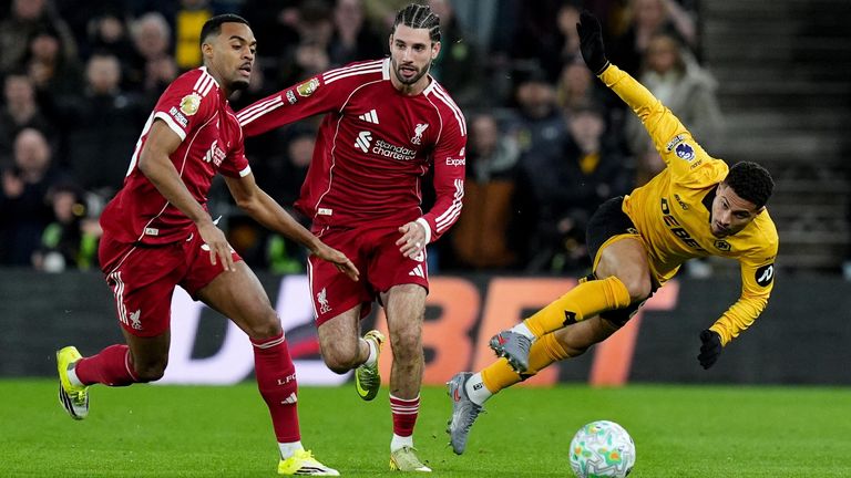 Joao Gomes tumbles under pressure from Dominik Szoboszlai and Ryan Gravenberch