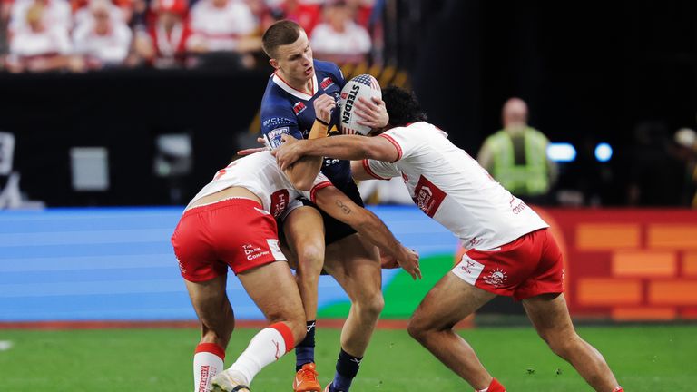 Picture by Alex Whitehead/SWpix.com - 28/02/2026 - Rugby League - Betfred Super League Round 3 - Hull KR v Leeds Rhinos - Allegiant Stadium, Las Vegas, USA - Ash Handley of Leeds is tackled by Hull KR