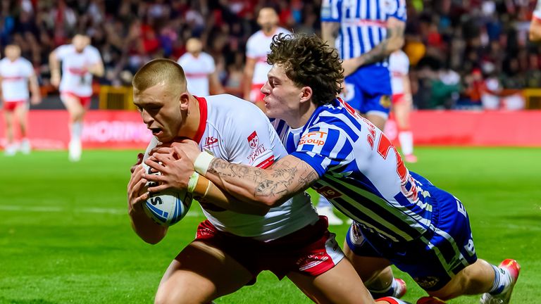 Picture by Allan McKenzie/SWpix.com - 27/03/2026 - Rugby League - Betfred Super League Round 6 - Hull KR v St Helens - Sewell Group Craven Park, Hull, England - Hull KR's Mikey Lewis slips between St Helens defenders to score his second try against St Helens.