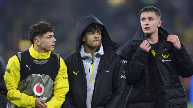Samuele Inacio of Borussia Dortmund and teammates Mathis Albert and Luca Reggiani celebrate victory in the Bundesliga match against Mainz