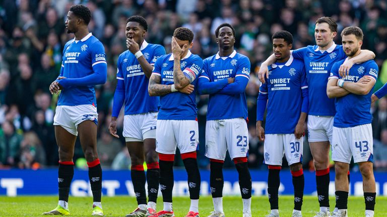 Rangers' James Tavernier (C) and teammates watch on during the penalty shoot-out