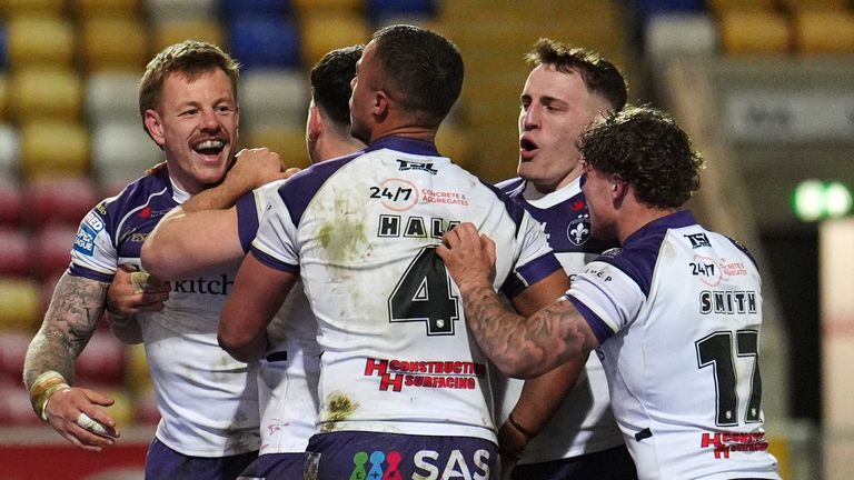 Wakefield Trinity's Tom Johnstone (left) celebrates with team-mates after scoring a try