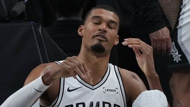 San Antonio Spurs forward Victor Wembanyama sits on the court after a hard fall