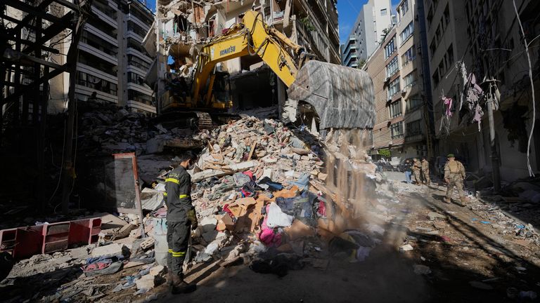 A Lebanese civil defense worker looks on as an excavator operates on the rubble of a building destroyed in an Israeli airstrike a day earlier in Beirut, Lebanon, Thursday, April 9, 2026. (AP Photo/Hussein Malla)
