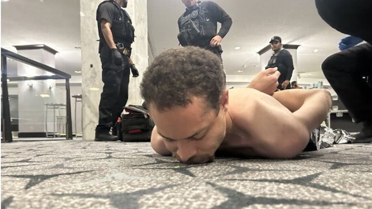 President Trump posted this photo of the alleged gunman being apprehended on his Truth Social platform