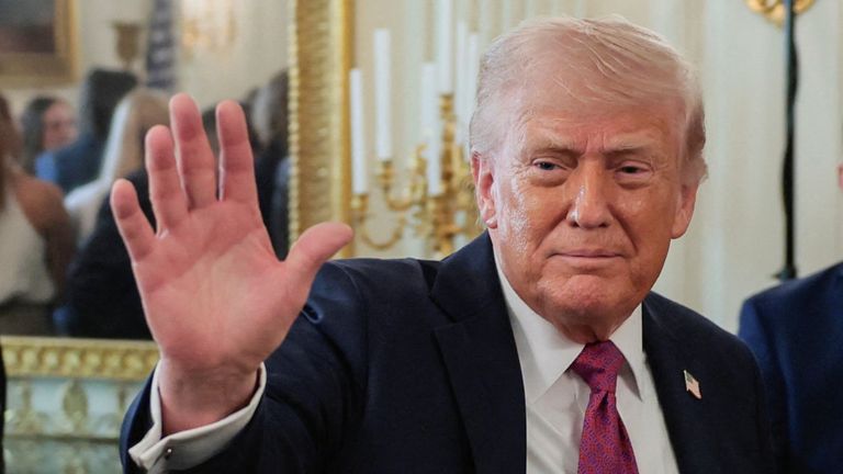 U.S. President Donald Trump waves as he departs after delivering remarks to NCAA Collegiate National Champions in the State Dining Room at t