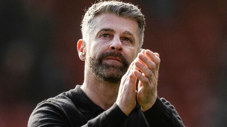 Aberdeen's Stephen Robinson applauds the fans at full time after earning his first win as head coach