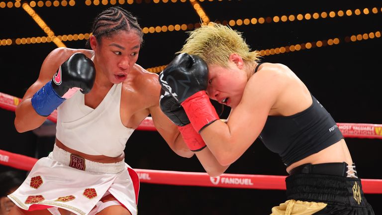Alycia Baumgardner lands a left hand on Bo Mi Re Shin before retaining the unified junior lightweight titles