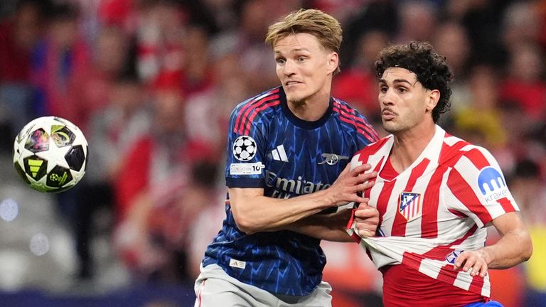 Arsenal's Martin Odegaard and Atletico Madrid's Joao Lucas Johnny battle for the ball